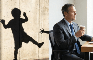 Berniuko psichologija: Kodėl daugelis vyrų taip ir neužauga? nuotraukoje subrendęs vyras sėdi ir berniuko šešėlis ant sienos